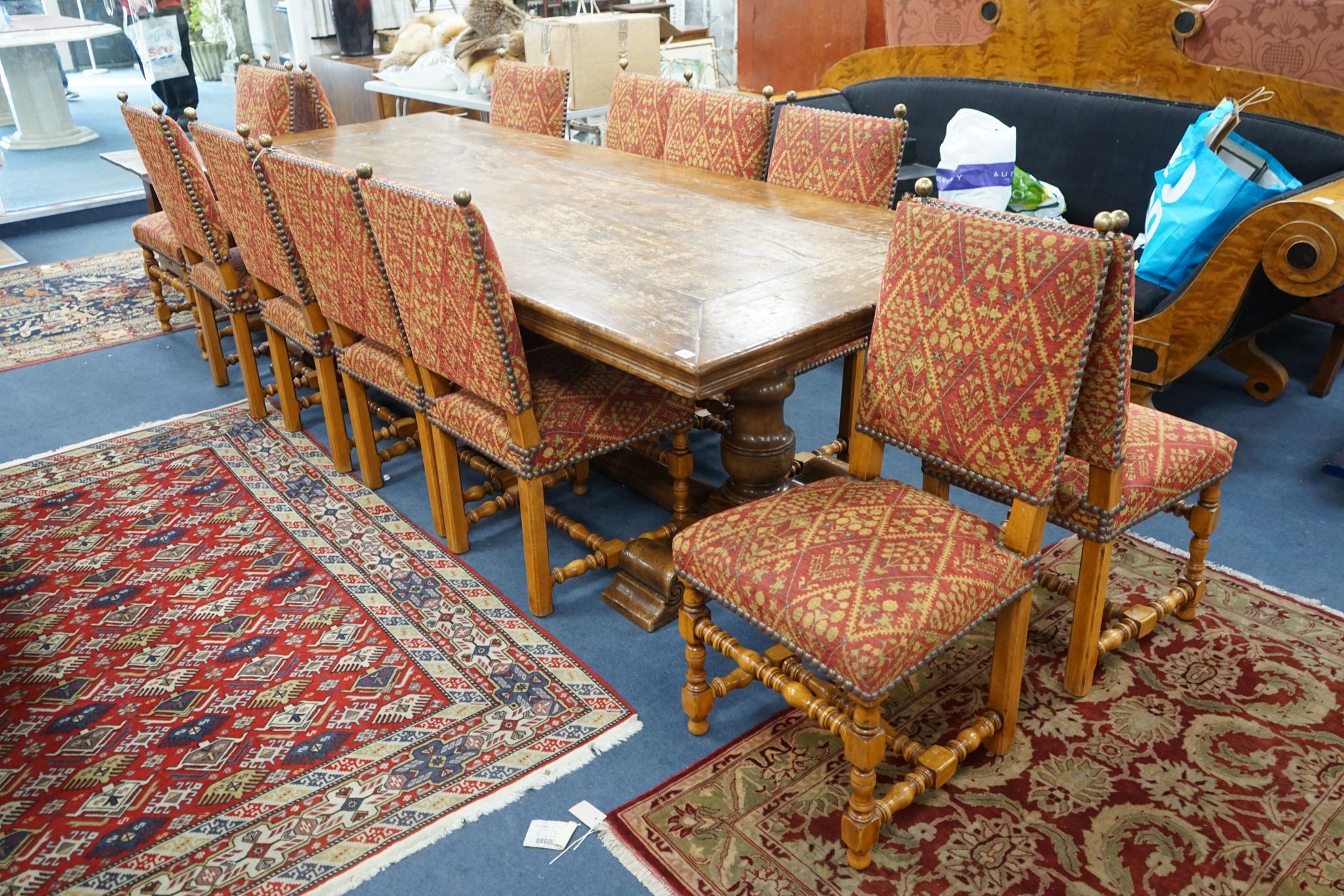 A set of twelve 18th century style French walnut dining chairs on turned underframes with H stretchers